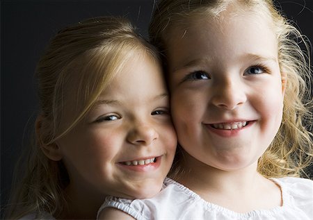 six girls friends - Close-up of two sisters smiling Stock Photo - Premium Royalty-Free, Code: 640-01357950