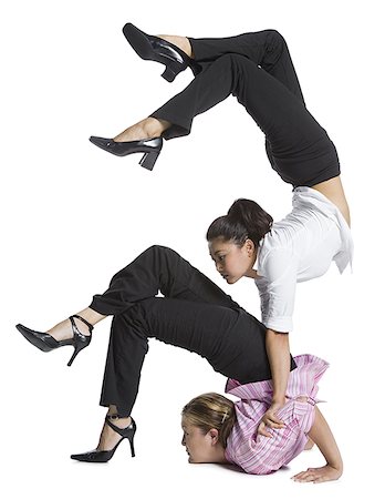 strong female acrobats - Two female contortionist businesswomen Stock Photo - Premium Royalty-Free, Code: 640-01358003