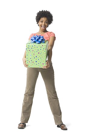 Portrait of a young woman holding a gift Stock Photo - Premium Royalty-Free, Code: 640-01358014