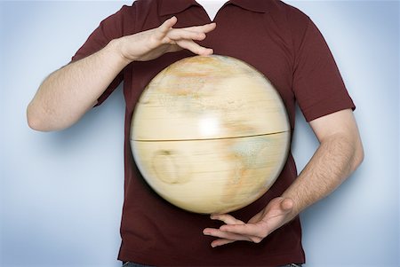 simsearch:700-00080719,k - Mid section view of a man holding a spinning globe Foto de stock - Sin royalties Premium, Código: 640-01358116