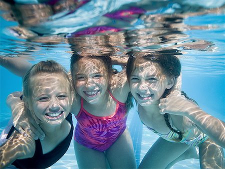 family underwater in a pool - Girls swimming underwater in pool Stock Photo - Premium Royalty-Free, Code: 640-01358199