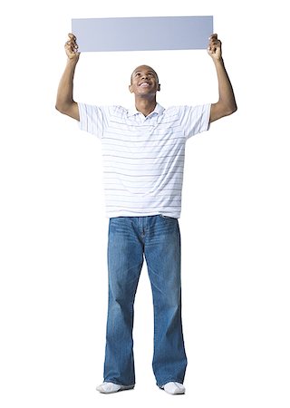 simsearch:640-01356873,k - Young man holding up a blank sign Stock Photo - Premium Royalty-Free, Code: 640-01358253