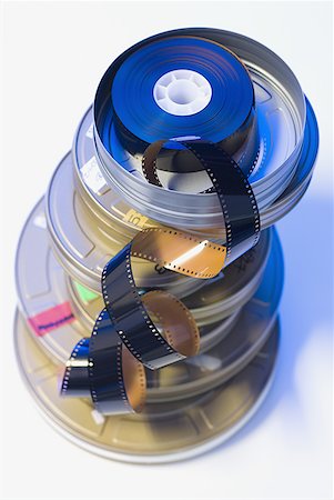 film production art - Film strip in pile of canisters Stock Photo - Premium Royalty-Free, Code: 640-01358357