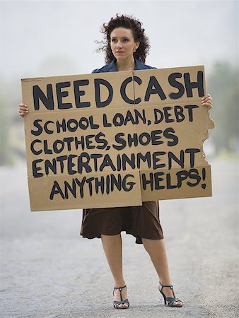 roadside assistance - Young woman holding a help-needed sign Stock Photo - Premium Royalty-Free, Code: 640-01358380