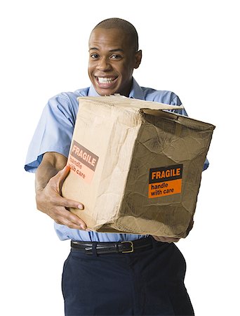 delivery african ethnicity - Portrait of a African-American mailman with a damaged package Stock Photo - Premium Royalty-Free, Code: 640-01358430