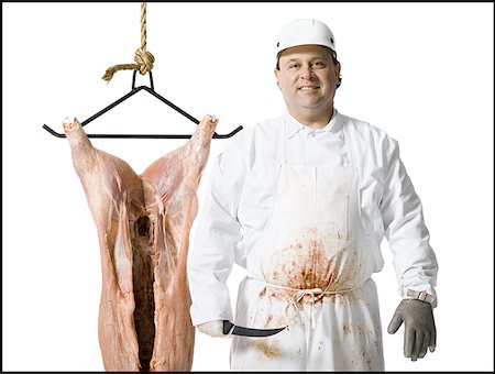 simsearch:640-02772428,k - Butcher standing with hanging carcass and knife Foto de stock - Sin royalties Premium, Código: 640-01358433