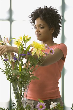 flowers curl - Young woman arranging flowers in a vase Stock Photo - Premium Royalty-Free, Code: 640-01358481