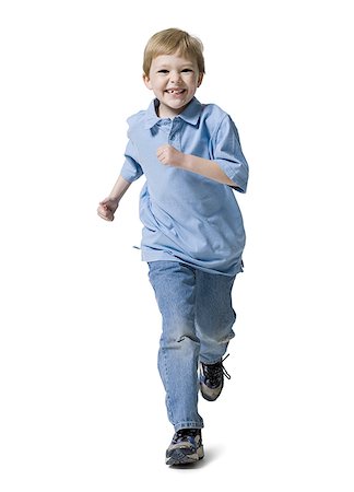 Boy running and smiling Stock Photo - Premium Royalty-Free, Code: 640-01358513