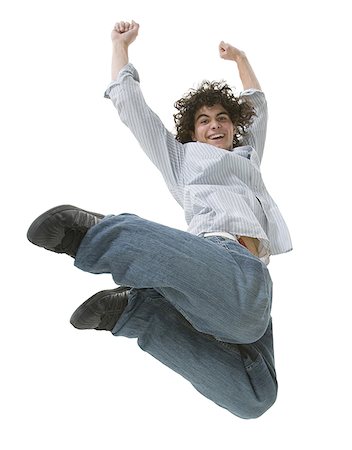 Low angle view of a teenage boy jumping in mid-air Stock Photo - Premium Royalty-Free, Code: 640-01358572