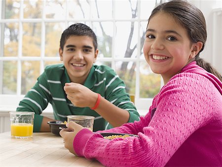 simsearch:640-03256844,k - Portrait of brother and sister sitting at a breakfast table Stock Photo - Premium Royalty-Free, Code: 640-01358588