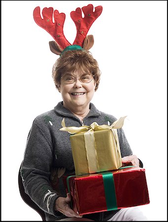 elderly characters - Portrait of a senior woman holding gifts and smiling Stock Photo - Premium Royalty-Free, Code: 640-01358615