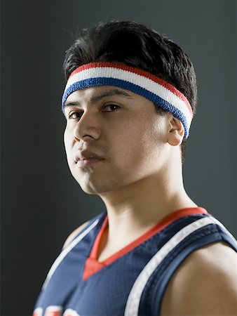 Portrait of a young man in a basketball jersey Stock Photo - Premium Royalty-Free, Code: 640-01358612