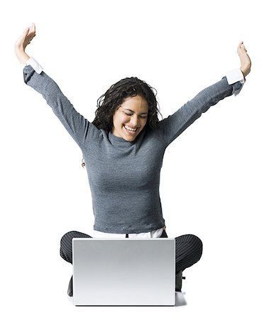 simsearch:640-01358649,k - Woman sitting cross legged with laptop stretching Fotografie stock - Premium Royalty-Free, Codice: 640-01358649