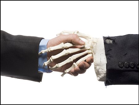 skeleton office meeting - Businessman shaking hands with skeleton Stock Photo - Premium Royalty-Free, Code: 640-01358665