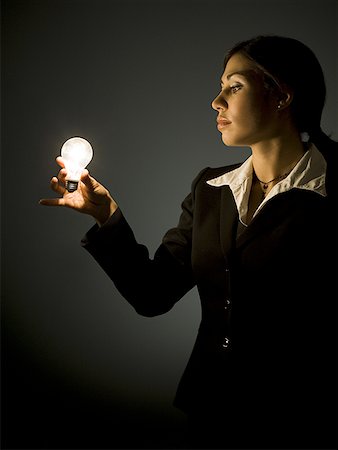 Profile of businesswoman with light bulb Stock Photo - Premium Royalty-Free, Code: 640-01358829