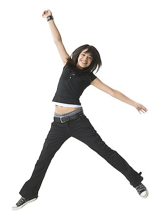 simsearch:640-01351032,k - Teenage girl jumping with her arm outstretched Fotografie stock - Premium Royalty-Free, Codice: 640-01358867