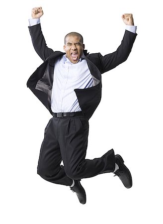 Portrait of a businessman smiling and jumping in mid-air Stock Photo - Premium Royalty-Free, Code: 640-01358925