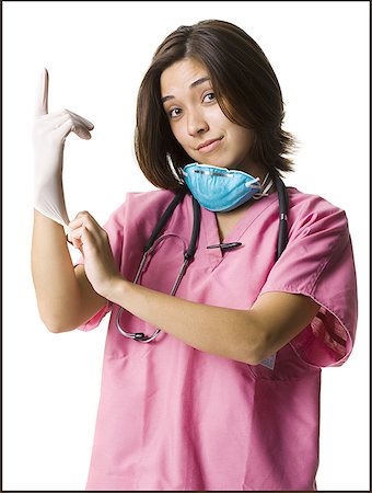 female doctor gloves mask scrub - Female doctor in pink scrubs with rubber glove Stock Photo - Premium Royalty-Free, Code: 640-01358956