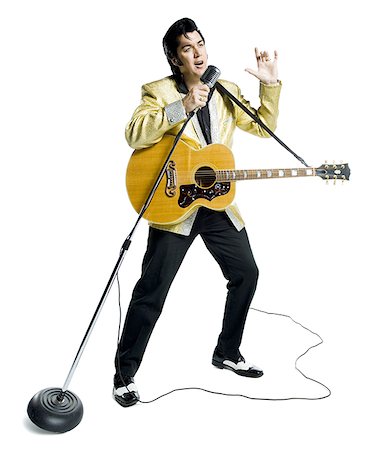 funny musician - An Elvis impersonator singing into a microphone Stock Photo - Premium Royalty-Free, Code: 640-01358960