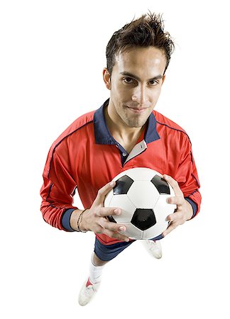 simsearch:640-01359251,k - Portrait d'un jeune homme tenant un ballon de soccer Photographie de stock - Premium Libres de Droits, Code: 640-01359006