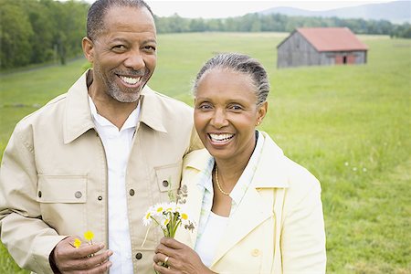person walking field flowers - Portrait of a senior man and a senior woman smiling Stock Photo - Premium Royalty-Free, Code: 640-01359007