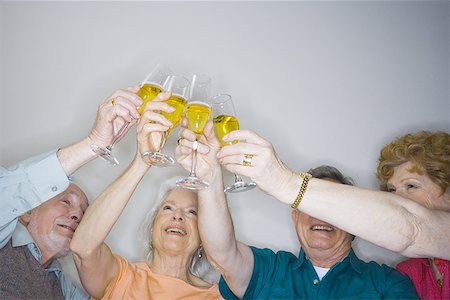 senior couple toasting - Low angle view of two senior couples making a toast Stock Photo - Premium Royalty-Free, Code: 640-01359124