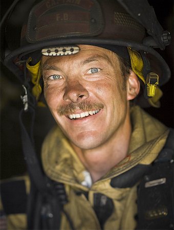 firefighter close - Close-up of a firefighter smiling Stock Photo - Premium Royalty-Free, Code: 640-01359145