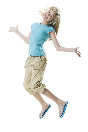 slippers girls - Portrait of a girl jumping and smiling Stock Photo - Premium Royalty-Free, Code: 640-01359261