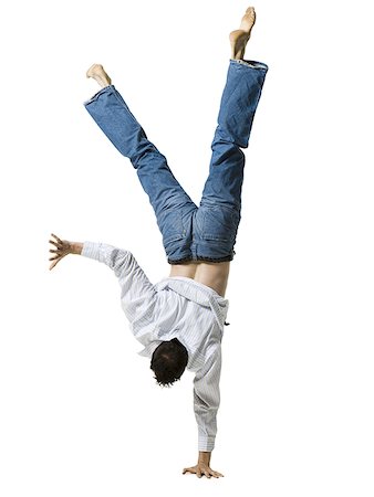 Man doing a one armed handstand Stock Photo - Premium Royalty-Free, Code: 640-01359341