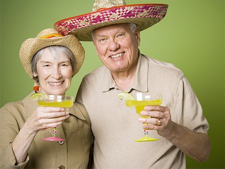 Portrait of an elderly couple holding glasses of lemon juice Stock Photo - Premium Royalty-Free, Code: 640-01359372