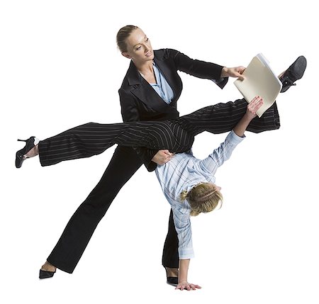 Two female contortionist businesswomen Stock Photo - Premium Royalty-Free, Code: 640-01359386
