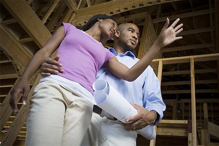 Low angle view of a young couple looking away Stock Photo - Premium Royalty-Free, Code: 640-01359394