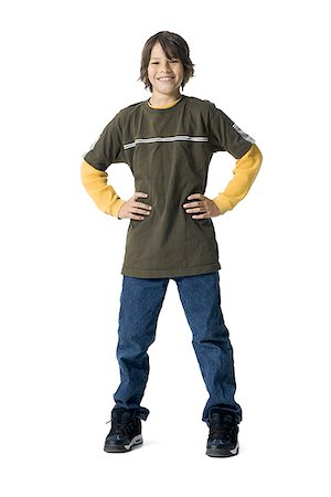 Portrait of a boy standing with arms akimbo Stock Photo - Premium Royalty-Free, Code: 640-01359401