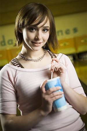 simsearch:640-03265586,k - Portrait of a teenage girl holding a disposable glass of cola and smiling Stock Photo - Premium Royalty-Free, Code: 640-01359518