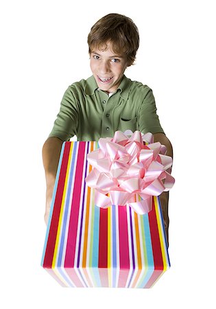 striped wrapping paper - High angle view of a boy giving a gift Stock Photo - Premium Royalty-Free, Code: 640-01359562