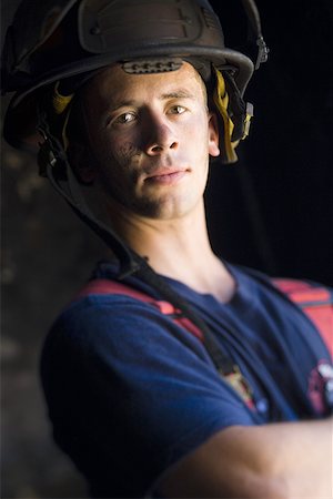 simsearch:640-01359145,k - Portrait of a firefighter wearing a safety helmet Stock Photo - Premium Royalty-Free, Code: 640-01359615