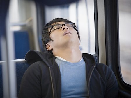 sitting on the bus - Close-up of a young man sleeping on a commuter train Foto de stock - Sin royalties Premium, Código: 640-01359646