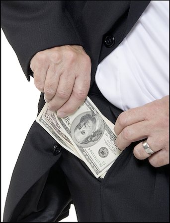 Mid section view of a man pulling out money from his pocket Fotografie stock - Premium Royalty-Free, Codice: 640-01359776