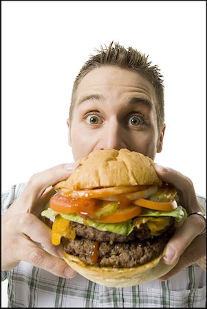 simsearch:640-01364192,k - Portrait of a young man holding a hamburger Foto de stock - Royalty Free Premium, Número: 640-01359840