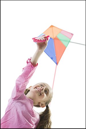 Close-up of a girl flying a kite Stock Photo - Premium Royalty-Free, Code: 640-01359856