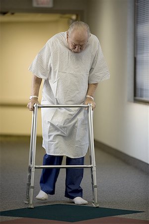 elderly person walking with walker in hospital - Male patient walking with a walker in a corridor Stock Photo - Premium Royalty-Free, Code: 640-01350158