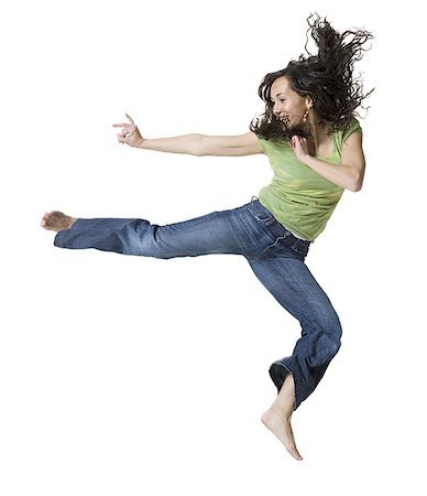 Young woman jumping Stock Photo - Premium Royalty-Free, Code: 640-01350207