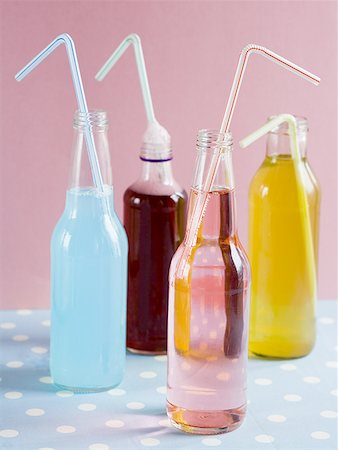 Four soda bottles with straws Stock Photo - Premium Royalty-Free, Code: 640-01350318