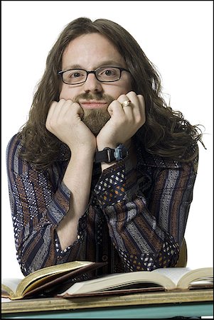 Portrait of a young man thinking with his hand on his chin Stock Photo - Premium Royalty-Free, Code: 640-01350319