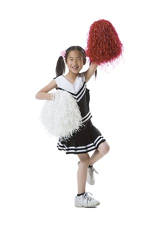 school skirt - Portrait of a cheerleader dancing with pom-poms Stock Photo - Premium Royalty-Free, Code: 640-01350336