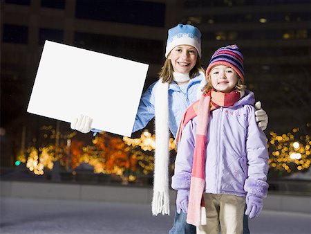 simsearch:640-01601334,k - Two girls outdoors in winter with blank sign Stock Photo - Premium Royalty-Free, Code: 640-01350358