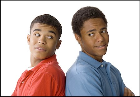 Close-up of a two young men standing back to back Stock Photo - Premium Royalty-Free, Code: 640-01350424