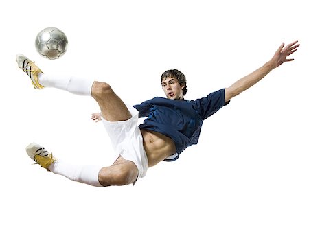 soccer player white background - Soccer player kicking ball Stock Photo - Premium Royalty-Free, Code: 640-01350447