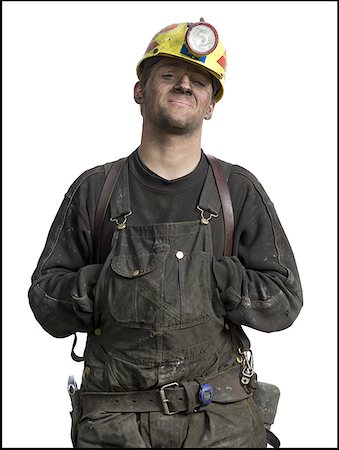 Portrait of a miner wearing a hardhat with a headlamp Stock Photo - Premium Royalty-Free, Code: 640-01350453