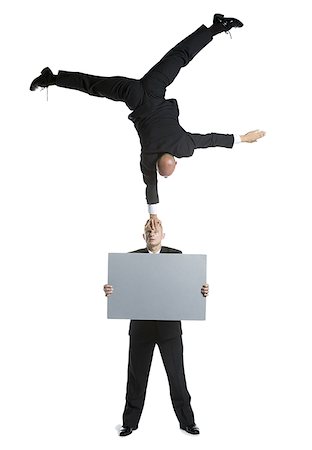 simsearch:640-02764552,k - Two male acrobats in business suits performing Foto de stock - Royalty Free Premium, Número: 640-01350498